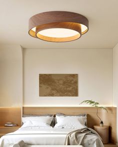 a large bed sitting under a round light fixture