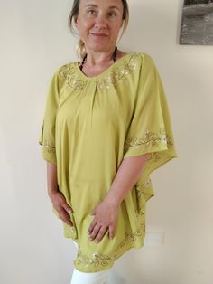 This is a poncho top or dress made with good quality cotton fabric which is delicately embroidered with a contionous floral design. It has been cut in a beautiful u shape at the bottom which will give a nice flow to the top.  It's ideal for summer, you can wear it at home to lounge around in or use it as a top over your jeans. It will even work ideally over your swim suit as a cover up.  Available in 3 colours and many sizes.  We do S/M , L/XL, and XL/XXL. Summer Beach Blouse With Butterfly Sleeves, Butterfly Sleeve Blouse For Beach, Short Sleeve Poncho For Vacation, Short Sleeve Spring Poncho For Vacation, Short Sleeve Poncho For Spring Vacation, Summer Lagenlook Tunic With Batwing Sleeves, Flowy Beach Tunic In Lagenlook Style, Flowy Lagenlook Tunic For Beach, Spring Vacation Poncho With Short Sleeves