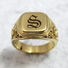 "The initial signet ring is a classic piece of jewelry for both men and women. Bring a little bling with this unique square-shaped initial signet ring in 24k gold plated brass with your choice of initial letters made especially for you. The monogram seal ring is polished to a high finish and decorated with a delicate ornamental design that will certainly be noticed as a refreshing element in any day or night outfit. This monogram ring is a perfect gift for a birthday, anniversary, as bridesmaid' Wedding Signet Ring Men, Signant Ring Mens, Initial Rings For Men, Promise Ring With Initials In 14k Gold, Timeless Gold Signet Ring For Promise, Classic Formal Signet Ring With Initials, Yellow Gold Engraved Initial Ring For Promise, Classic Signet Ring With Initials, 14k Gold Signet Ring With Engraving Option For Promise