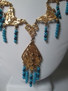 Beautiful gold tone Egyptian revival vintage necklace with blue turquoise plastic beads in excellent condition and measures 18 inches long with a 3 inch drop center. Celluloid Jewelry, Cuyahoga Falls, Puffy Heart Charms, Egyptian Revival, Toggle Bracelet, Puffy Heart, Plastic Beads, Drop Necklace, Blue Turquoise