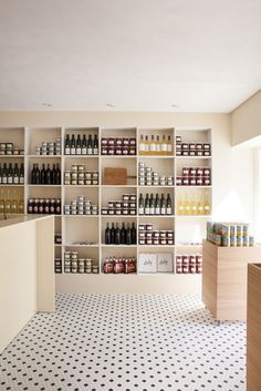 an empty store with shelves filled with bottles