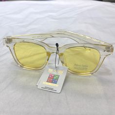 Clear/Yellow Sunglasses Clear Polarized Sunglasses For Spring, Spring Clear Polarized Sunglasses, Casual Gold Wayfarer Sunglasses, Trendy Yellow Sunglasses For Party, Yellow Mirrored Sunglasses For Summer, Summer Yellow Sunglasses With Mirrored Lenses, Clear Glass Sunglasses For Vacation, Clear Sunglasses With Uva Protection, Spring Clear Sunglasses With Uva Protection