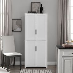 a white cabinet in the corner of a room