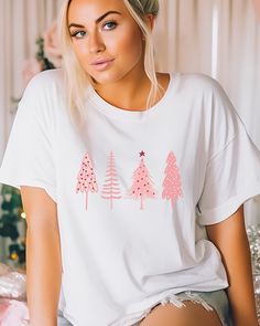 🎄 Pretty in Pink for the Holidays! 🌸 Elevate your Christmas style with our charming Pink Christmas Tree shirt. Perfect for adding a pop of festive elegance to your holiday wardrobe. ✨ Available now to make your season merry and bright. 💖👕 White Casual Christmas Shirt, Christmas Pink Cotton Tops, Cute Winter T-shirt For Gift, Pink Cotton Christmas Tops, White Winter Tops As Gift, White Winter Tops As Gifts, White Winter Tops For Gifts, White Winter Tops As A Gift, Cute Holiday T-shirt For Winter