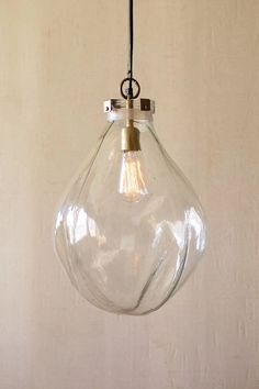 a clear glass light hanging from a ceiling