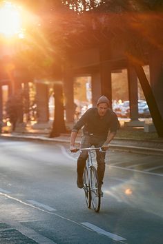 the man is riding his bike down the street