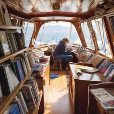 a woman sitting in a chair on top of a boat next to bookshelves