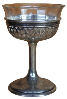 an ornate glass bowl on a metal stand