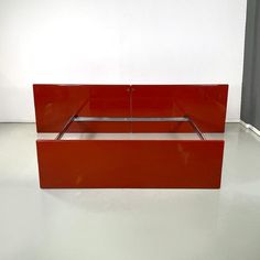 a red bed sitting on top of a white floor