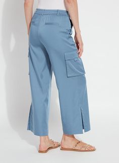 Made from Fluid Stretch Satin, the Calypso Ankle Cargo Pant is a chic, yet casual wardrobe staple. These silky cargos offer a flat front, elasticated back waist, beltloops with D ring, back faux welt pockets, front side pockets and front cargo pockets. Cropped with a relaxed fit and wide stitched hem, the Calypso Ankle Cargo Pant also features outer seam side slits. Style these Stretch Satin cargo pants with our Avril Sculpting Tank and Avril Knit Duster, or the simple Classic Top. Upon deliver Casual Blue Pants With Flap Pockets, Blue Utility Pants With Flap Pockets, Blue Straight Leg Pants With Flap Pockets, Blue Straight-leg Pants With Flap Pockets, Versatile Blue Pants With Pockets, Versatile Blue Wide Leg Pants With Pockets, Relaxed Fit Blue Cargo Pants With Belt Loops, Blue Tapered Leg Cargo Pants With Elastic Waistband, Blue Cargo Pants With Elastic Waistband And Tapered Leg