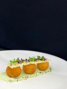 three small appetizers on a white plate