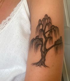 a woman with a tree tattoo on her arm