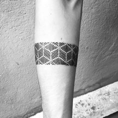 a black and white photo of a person's arm with a tattoo on it