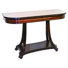 a wooden table with marble top and black base