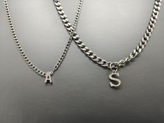 "Mens Gold Silver Initial Necklace, Letter Charm Pendent, Curban Chain, Personalized Gift for Dad, Husband, Boyfriend, Brother and Son. This Necklace can be made by Silver and Gold PVD coating on Stainless Steel which is tarnish resistant, waterproof, same functions as 18K gold filled.  
 Our shop is committed to excellence, offering you a product that not only meets but exceeds your expectations. 
 ✔ EXCEPTIONAL CRAFTSMANSHIP: Each of our bracelets is a masterpiece of detail and design, individually tailored to the perfect length for a personalized touch that's distinctly you. 
 ✔ DURABILITY AND QUALITY: Our quality control system is stringent, ensuring each bracelet undergoes thorough inspection. Made with durable high quality Stainless Steel, our chains are built to last. 
 Key Specific Trendy Silver Charm Necklaces For Gifts, Trendy Personalized Silver Necklaces, Trendy Silver Charm Necklace For Personalized Gift, Trendy Silver Necklaces For Personalized Gifts, Trendy Silver Necklace For Personalized Gift, Trendy Hypoallergenic Charm Necklaces For Gift, Trendy Hypoallergenic Charm Necklaces As Gifts, Trendy Hypoallergenic Charm Necklace For Gift, Trendy Silver Hypoallergenic Charm Necklace