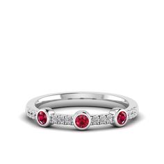 This exquisite diamond and ruby ring is a stunning piece of jewelry that exudes elegance and sophistication. The brilliant diamonds and vibrant rubies are set in a beautifully crafted, creating a luxurious and eye-catching design that is sure to make a statement. Metal: 14K Gold Setting Type: Prong Rhodium Finish: Yes, on White Gold Gemstone Details: Gemstone: Ruby Shape: Round Average Dimensions: 2.50 MM Quantity: 03 Average Cut: Very Good Average Color: Medium to Dark Red Average Clarity: Eye Ruby Ring With Diamond Accents Fine Jewelry, Dazzling Red Diamond Ring With Diamond Accents, Dazzling Red Diamond Ring With Accents, Elegant Three Stone Red Diamond Ring, Luxury Diamond Ring With Lab-created Ruby Accents, Elegant Three-stone Red Diamond Ring, Diamond White Ruby Ring With Diamond Accents, Red Diamond Ring With Accents, Elegant Red Three Stone Diamond Ring