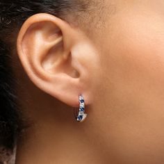 Timeless and beautifully modern, these half huggie earrings are a great choice for every occasion as they showcase glittering diamonds and sparkling sapphires of graduating sizes along the top half. A smooth and sleek high polished plain metal portion mirrors the gemstone studded half to complete the bottom portion of the earring. The size is subtle enough for every day wear and will take you seamlessly into the evening hours as well. Metal: 18kt Gold Sapphire Weight: 0.50 ct. Diamond Weight: 0. Anniversary White Gold Huggie Earrings With Sparkling Stones, Fine Jewelry Sapphire Hoop Earrings In White Gold, White Gold Diamond Huggie Earrings With Sparkling Stones, Elegant Sapphire Hoop Earrings With Prong Setting, Diamond Huggie Earrings With Sparkling Stones In White Gold, Gemstone Huggie Earrings For Anniversary, Fine Jewelry Huggie Earrings With Sparkling Stones, Elegant Sapphire Huggie Jewelry, Elegant Sapphire Huggie Earrings