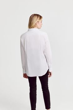 The Icon Shirt runs tailored at the waist, chest and back.  For a contemporary fit, order true size.  For a blousier fit, size up, or consider The Boyfriend Shirt for an even looser look.

 Our perfect fit cotton stretch button down. We designed our best-selling Icon Shirt to be fitted throughout, giving you a body-hugging shape yet eliminating blouse gape completely.  Our cotton stretch is sourced from a family-run mill in Spain and produced in our factory in Portugal by a local team of artisan Modern Workwear Tops With Concealed Placket, Modern Tops With Concealed Placket For Workwear, Modern Tops For Workwear With Concealed Placket, Classic Tailored Tops For Office, White Office Top With Shirttail Hem, Classic Tailored Office Tops, Classic Tailored Office Top, Modern Tops With Shirttail Hem For Work, Modern Formal Tops With Shirttail Hem