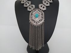 Necklace with details of rhinestones and turquoise stone, a unique boho necklace made of metal alloy silver plated unique gift Collier avec des détails de strass et de pierre turquoise, un collier boho unique en alliage de métal plaqué argent cadeau unique Halskette mit Details aus Strass und türkisfarbenem Stein, eine einzigartige Boho-Halskette aus Metalllegierung versilbert einzigartiges Geschenk Halskæde med detaljer af rhinsten og turkis sten, en unik boho halskæde lavet af metallegering sø Bohemian Turquoise Pendant Necklace With Oxidized Finish, Bohemian Silver Rhinestone Necklace For Gift, Bohemian Silver Rhinestone Necklace As A Gift, Festival Silver Necklace With Jewels, Bohemian Silver Rhinestone Necklace, Silver Bohemian Rhinestone Necklace, Silver Jewelry With Jewels For Festivals, Elegant Silver Rhinestone Necklace For Festivals, Bohemian Silver Rhinestone Necklace With Jewels