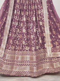 This purple jacquard lehenga ensemble, adorned with intricate zari embroidery and dazzling sequin work. The majestic hue of purple radiates sophistication and allure, making it an ideal choice for weddings, festivities, and special occasions. Crafted from luxurious jacquard fabric, the lehenga boasts a semi-stitched design, offering a comfortable fit of up to 42 inches while allowing freedom of movement.
Accompanying the lehenga is a matching jacquard choli, intricately embellished with zari emb Jacquard Lehenga, Sangeet Lehenga, Engagement Gown, Lehenga Crop Top, Lehenga Choli Wedding, Floral Lehenga, Party Wear Lehenga Choli, Reception Gown, Zari Embroidery