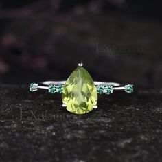 Item description ✦ Handmade item! ✦ Material: 925 sterling silver, Solid 10k/14K/18K GOLD (can be made in white/rose/yellow gold) Engagement ring ✦ Center stone: Natural Peridot ✦ Size/Weight: 6x8mm Pear Cut ✦ Side stones: Round Cut Natural Emerald Any ring size can be made,if the ring size is not in the option list ,contact me. As it is handmade,it needs 2-4 weeks to finish and then be shipped by usps or DHL. Return policy: We offer 30 days return policy. For any reason, if you are not completely satisfied with your order, you may return it for a refund.  Buyer is responsible for the handcraft fee (15%-30% of the total price) and the return shipping cost. Emerald Cut Peridot Ring, Unique Green Peridot Rings, Emerald Cut Peridot Green Ring, Emerald Cut Peridot Ring In Green, Peridot Rings With Polished Finish, Art Deco Emerald Ring, Peridot Engagement Rings, Art Deco Wedding Rings, Yellow Gold Engagement Rings