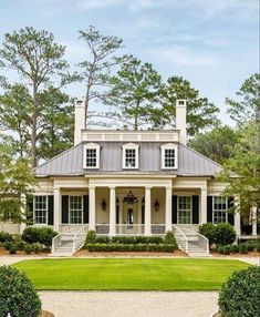 a large white house surrounded by trees and bushes