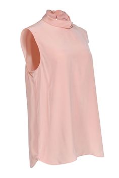 Add a touch of luxury to your wardrobe with St. John's sleeveless silk top. The peachy pastel color and draped turtleneck add a playful twist to your look. Crafted from fluid crepe de chine, this elegant top can be dressed up or down for any occasion. Size L 100% Silk Back keyhole w/ button closure Sleeveless Draped turtleneck Bust 41" Waist 44" Shoulder to hem 28.75" Pink Silk Tank Top For Spring, Chic Pink Tank Blouse, Chic High Neck Silk Top, Chic Silk High Neck Top, Sleeveless Pink Silk Blouse, Chic Peach Sleeveless Tank Top, Gold Sleeveless Silk Top, Pink Sleeveless Silk Top, Luxury Orange Sleeveless Tops