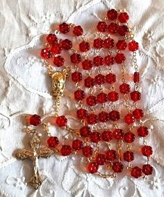 "See more of our rosaries at https://prayertoolbox.etsy.com Offering you a handmade new glass bead rosary made in the Czech Republic.  The 8mm diameter floral beads are transparent red in color.  Gold finish.  Italian made & designed crucifix measures 1.5\" long x 1\" wide.  Rosary length is 23\" long.   Comes gift boxed with card of origin." Red Beaded Rosary For Spiritual Use, Handmade Red Rosary For Jewelry Making, Red Rosary Beads For Jewelry Making, Red Spiritual Rosary As Gift, Red Beaded Rosary With Round Beads, Handmade Red Rosary With Cross, Handmade Red Rosary, Handmade Red Cross Rosary, Flower Rosary