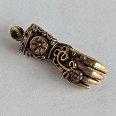 This gorgeous glove charm is highly ornate with exquisite details -- maybe baroque in style? The charm is perfect for a bracelet or necklace and brings to mind Victorian gloved ladies seeking out suitors at a ball. I'm not certain how many carats the gold is, but from researching, I believe it to be 14 or 18ct. It is possible that these are metal gold plated/coated. Measures approximately 7/8" in length I have NOT attempted to clean it as I do not want to damage the integrity of the piece. Free Antique Hand Cast Gold Jewelry, Antique Gold Hand Cast Jewelry, Antique Hand-cast Gold Jewelry, Victorian Gold Jewelry With Charms, Ornate Pendant Jewelry With Charms, Elegant Bronze Jewelry With Charms, Victorian Metal Jewelry With Lobster Clasp, Victorian Jewelry With Lobster Clasp In Brass, Victorian Metal Jewelry With Charms