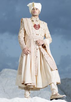 Gold Anarkali Sherwani With Dupatta, Gold Anarkali Sherwani With Zari Work, Gold Sherwani With Dupatta For Reception, Festive Gold Anarkali Set With Naqshi, Gold Anarkali Sherwani In Raw Silk, Gold Anarkali Style Sherwani In Raw Silk, Anarkali Traditional Wear With Gold Embroidery For Ceremonial Occasions, Anarkali Ceremonial Dress With Gold Embroidery, Bollywood Style Gold Churidar With Naqshi