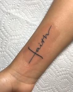 a tattoo with the word faith written on it's arm and an arrow in the middle