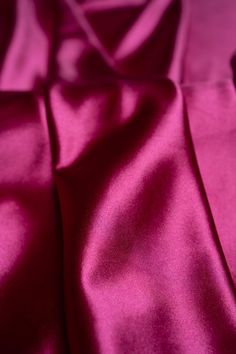 a close up view of a pink satin fabric