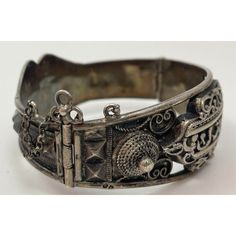 Antique Moorish North Africa Silver Cuff Bracelet. Antique Tunisian, Algeria or Moroccan silver cuff. In good condition, sturdy and high quality design, Maker's mark on outer edge. A well made silver bracelet from North Africa from the French Colonial Times. The Arabic calligraphy is stylized Arabic script. This type of bracelet was produced for European rather than local consumption and were mentioned in the seminal work of Paul Eudel: Dictionnaire des bijoux de l'Afrique du Nord : Maroc, Algérie, Tunisie, Tripolitaine (1906). They were known as "Meqiâsat Tounès" or Tunis bracelets, because they mimic a style of bracelet that was originally made in Tunis after the Turkish Islamic design. Vintage Moorish Etruscan Style Silver Filigree Hinged bangle with Islamic Arabic Calligraphy. A beauti Luxury Silver Cuff Bracelet For Ceremonial Wear, Silver Collectible Cuff Bracelet, Heavy Vintage Silver Cuff Bracelet, Vintage Silver Solid Cuff Bracelet, Antique Silver Cuff Bracelet, Silver Polished Cuff Bracelet For Ceremonial Use, Collectible Silver Cuff Bracelets, Collectible Silver Cuff Bracelet, Collectible Cuff Bangle With Intricate Design