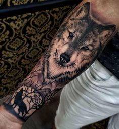 a man with a wolf tattoo on his arm