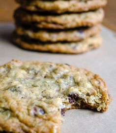 a stack of cookies sitting on top of a table next to each other with one bite taken out