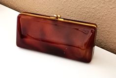 a brown purse sitting on top of a white table next to a wall and floor