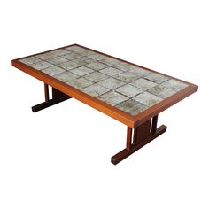 a wooden table with tile top and legs