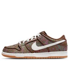 The Nike Dunk Low Pro Premium SB 'Paisley' is a stylish sneaker inspired by 70's T-shirts. It features a brown upper with a Paisley print, and a mix of pink, green and burgundy. The white Swooshes on the side, along with the matching tongue and heel branding, complete the design on a white midsole and rubber sole. Perfect for everyday wear, this sneaker is also suitable for a variety of activities such as skateboarding and casual outings. This adult-sized sneaker is part of the Nike SB Dunk Low series and is set to release on 2022-03-29. (SNKR/Skate/Unisex/Low Top) Brown Retro Custom Sneakers For Streetwear, Nike Retro Brown Sneakers, Nike Casual Sneakers With Graphic Print, Vintage Nike Brown Sneakers, Vintage Brown Nike Sneakers, Retro Brown Sneakers For Skateboarding, Dunk Low Paisley, Nike Sb Dunk Low Pro, Dunk Low Nike