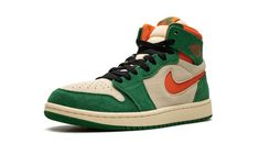 The Air Jordan 1 High Zoom CMFT 2 "Pine Green" is a colorway of the modified version of the retro basketball shoe with green and orange details.  The Jordan 1 Zoom Comfort 2 is the second version of the Jordan 1 Zoom Comfort shoe that puts a casual, more comofrtable spin on the classic silhouette.  The “Pine Green” features a Muslin suede base with Pine Green suede overlays.  An Orange Blaze cut-out Swoosh appears on the sides and a “Wings” logo is found on the collar.  “Zoom Air” branding repla Orange Details, Retro Basketball Shoes, Retro Basketball, Comfort Shoe, Wings Logo, Stadium Goods, Pine Green, Air Jordan 1 High, Jordan 1 High