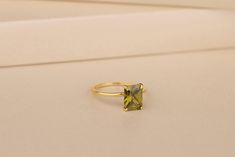 This small and delicate Peridot Birthstone Ring is the perfect addition to your collection. Each ring is made with 10K, 14K and 18K gold solid or 925 sterling silver features an intricate setting for a truly unique look. The Peridot is one of the most precious gemstones known to man, naturally green in color and beautifully bright. This lovely petite-sized ring will add just the right amount of sparkle to any outfit! Details of the product Material: 10K and 14K, 18K Solid Gold, Silver Gemstone: Peridot Gemstone Gemstone Size: 7x9 mm Unique Gift For people whom you love; Mom, Girlfriend, Wife, Fiance, Best Friend; Dainty Gift Idea; Valentine's Day Gift, Birthday Gift, Anniversary Gift, Gift For Engagement or Wedding, Promise Gift, Christmas Gift, Black Friday Gift, Mother's Day Gift, Intern Green Citrine Rings For Gifts, Minimalist Green Crystal Wedding Ring, Minimalist Yellow Ring As Gift, Minimalist Yellow Rings For Gift, Peridot Ring Gold, Peridot Birthstone Ring, Peridot Birthstone, August Birthstone, Peridot Ring