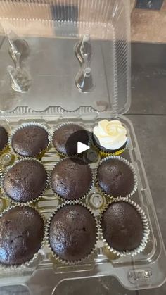 cupcakes sitting in a plastic container on top of a table