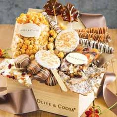 a wooden box filled with lots of different types of snacks and treats on top of a table