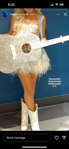 a woman in a white dress holding a guitar