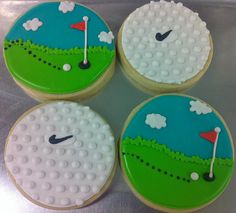 four decorated cookies in the shape of golf balls