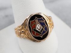 This antique fraternal ring represents the Junior Order of United American Mechanics! The enamel detailing is crisp and bold, and the scrolling designs on the ring's shoulders have a textured relief that feels luxurious. What a great ring! Metal: 10K Yellow and Rose Gold Materials: Black, Red, White, and Blue Enamel Top Measurements: 12 x 15 mm, Oval Ring Size: 11.75 Marks: "OB 10K" Stamped on the inside band Antique Enamel Ring Collectible, Antique Engraved Enamel Ring For Anniversary, Antique Engraved Enamel Ring For Formal Occasions, Antique Black Enamel Rings For Collectors, Ceremonial Heirloom Enamel Ring In Yellow Gold, Antique Enamel Rings For Formal Occasions, Heirloom Yellow Gold Enamel Ring For Ceremonial Occasions, Ceremonial Heirloom Yellow Gold Enamel Ring, Heirloom Ceremonial Enamel Ring In Yellow Gold