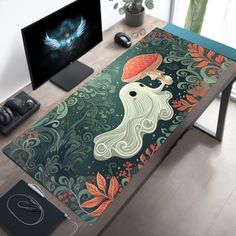 a computer desk with a painting on it