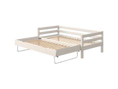 a white bed frame with wooden slats