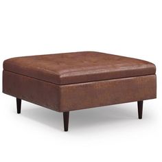 a brown foot stool sitting on top of a white floor