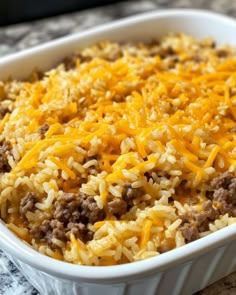 a casserole dish with cheese and ground beef