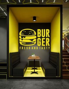 the interior of a fast food restaurant with yellow walls and black booths on either side